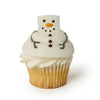 Cupcake decorated with a melting snowman marshmallow on top on a white background