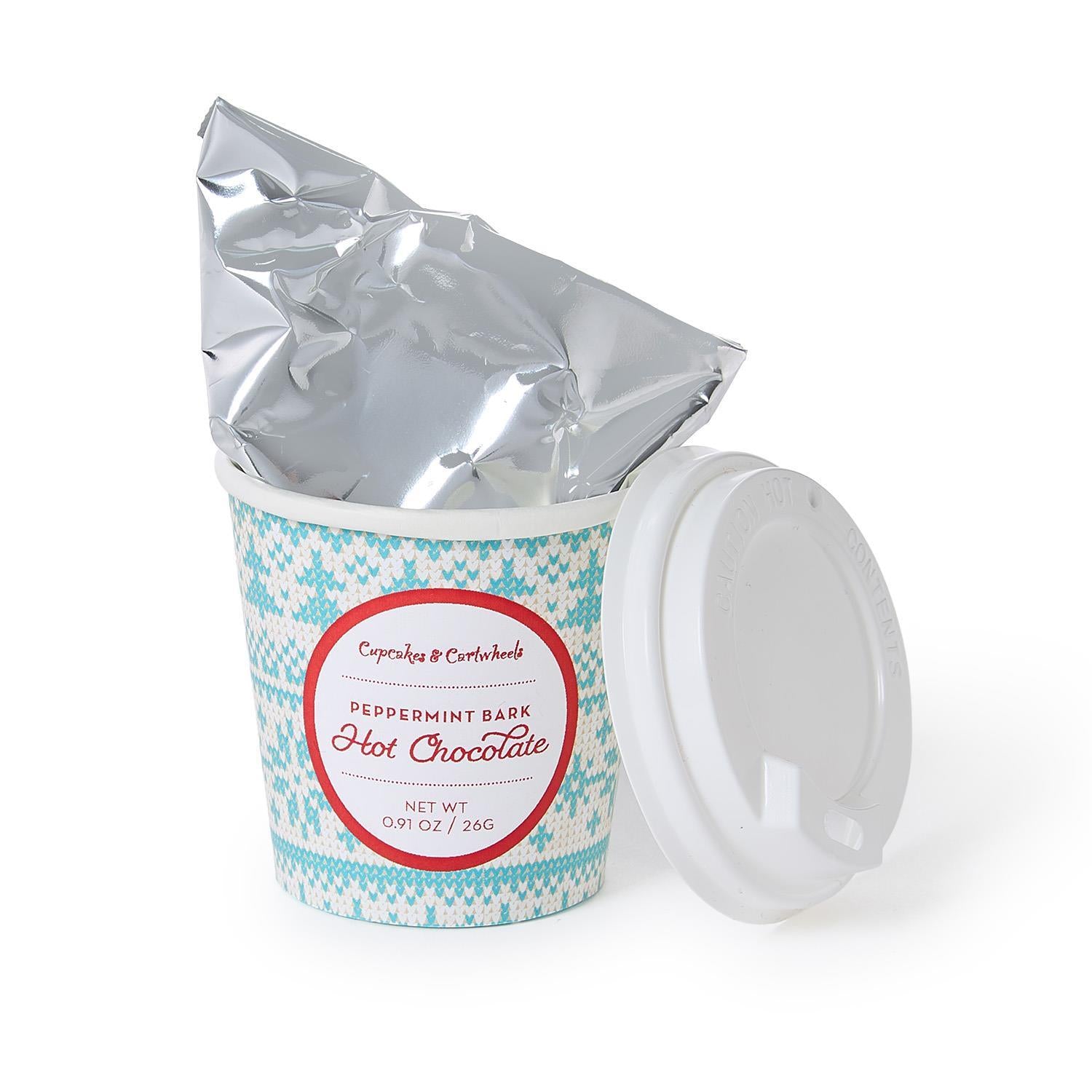 Cup of hot chocolate with peppermint bark flavor packaging on a white background