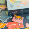 Pipi Post product with colorful map-themed packaging and stickers on a dark surface
