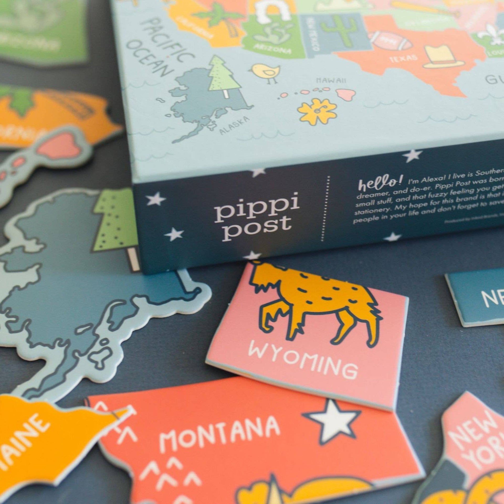Pipi Post product with colorful map-themed packaging and stickers on a dark surface