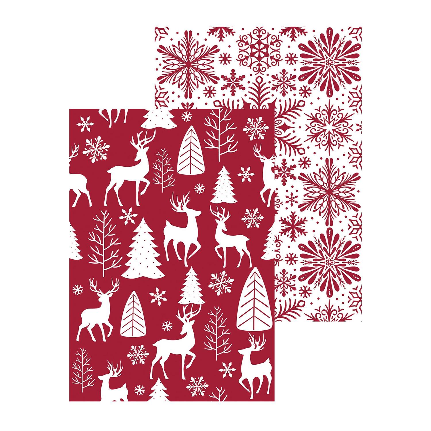 Red and white Christmas-themed reversible towel showing both sides with reindeer, trees, and snowflakes on a white background.