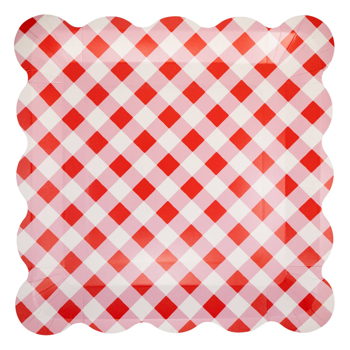 Red and white gingham paper plate with scalloped edge on a white background
