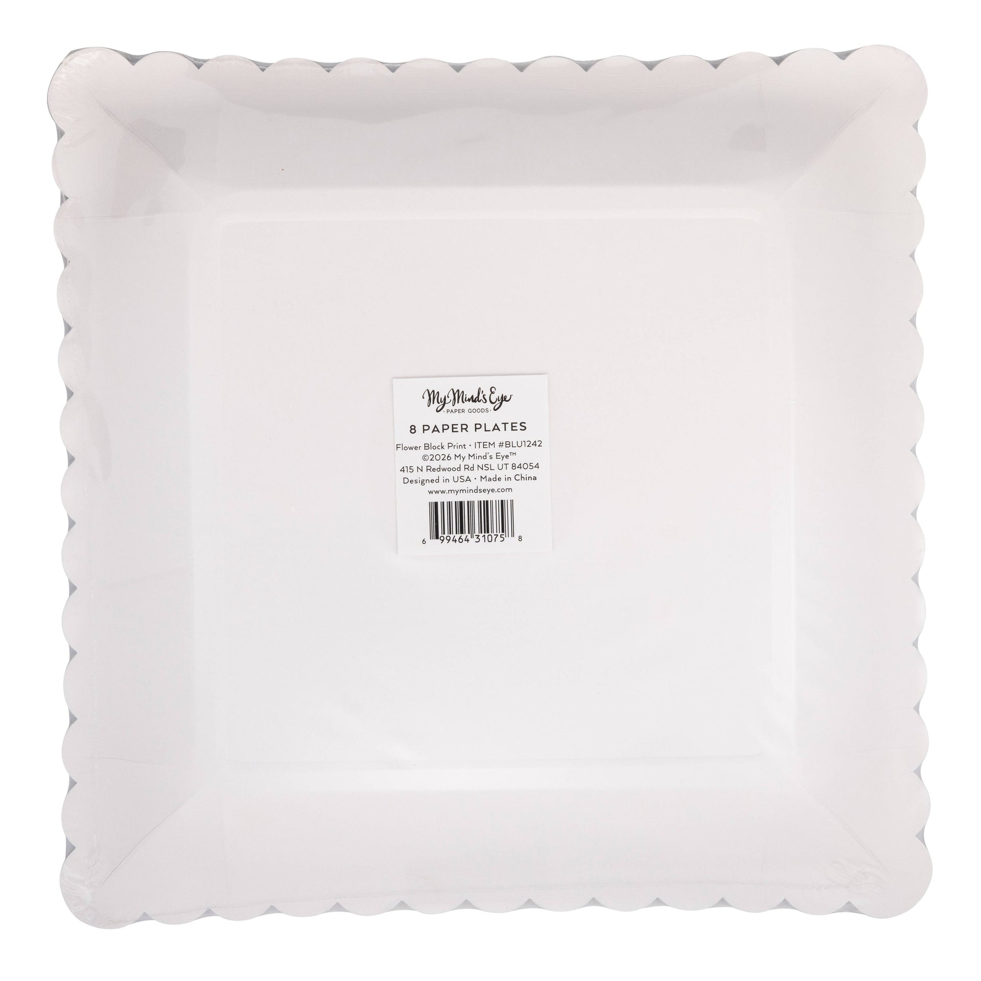 Bottom view of scalloped edge paper plate in a box with a visible brand label on a white background