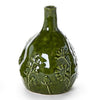 Green ceramic vase with floral patterns on a white background