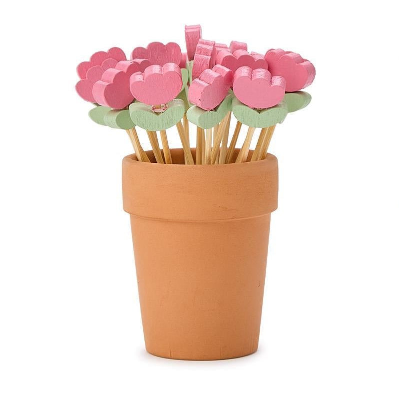 Terracotta pot with pink flower-shaped toothpicks on a white background