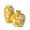 Two yellow vases with white floral patterns on a white background