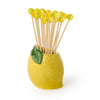 Yellow lemon-shaped toothpick holder with cocktail skewers on a white background