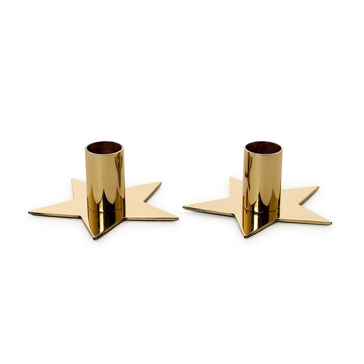 Two gold candle holders shaped like stars on a white background