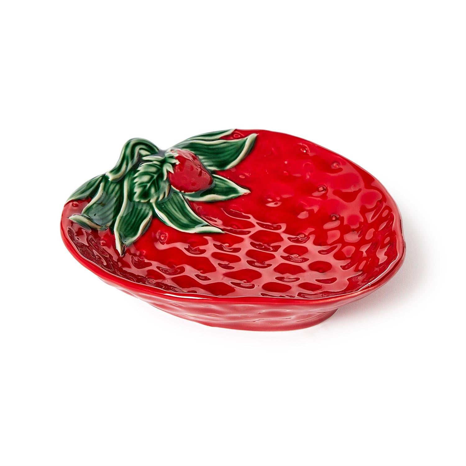 Red strawberry-shaped dish with green leaves on a white background