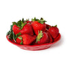 Red strawberry-shaped plate filled with strawberries on a white background