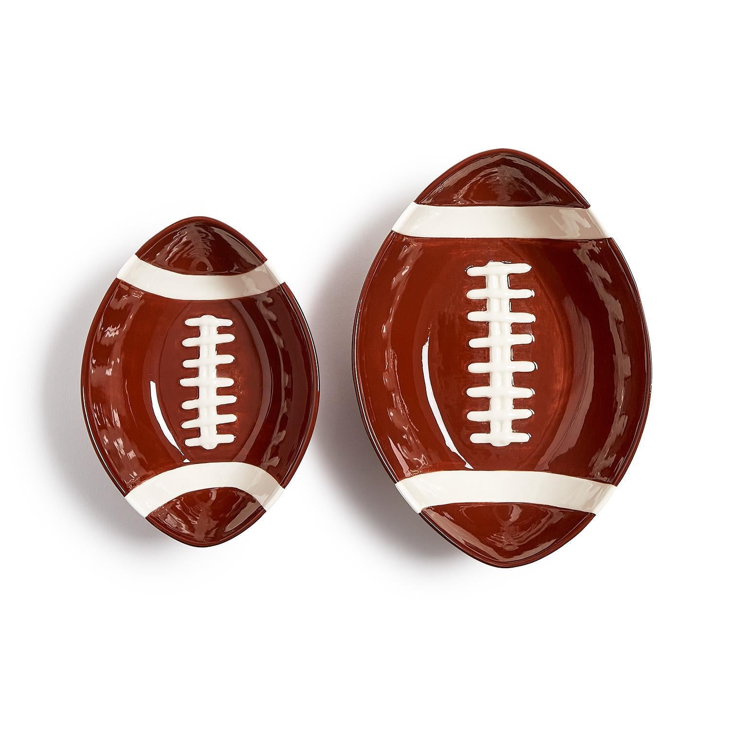 Two football-shaped dolomite bowls on a white background