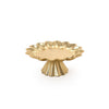 Gold decorative cake stand with scalloped edge on a white background