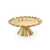 Gold decorative cake stand with scalloped edge on a white background