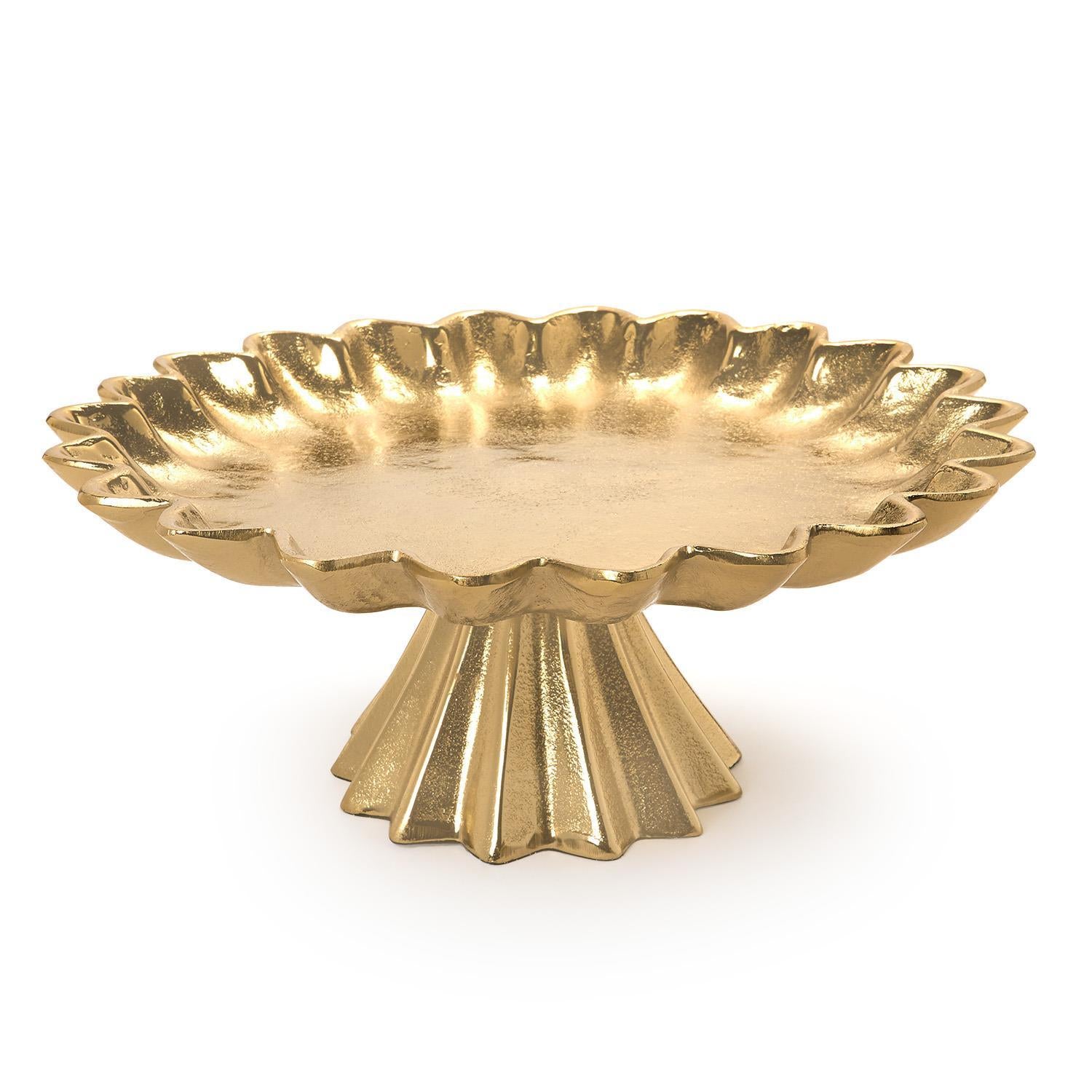 Gold decorative cake stand with scalloped edge on a white background