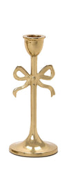 Gold candle holder with bow design on a white background