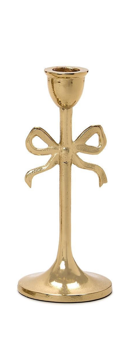 Gold candle holder with bow design on a white background