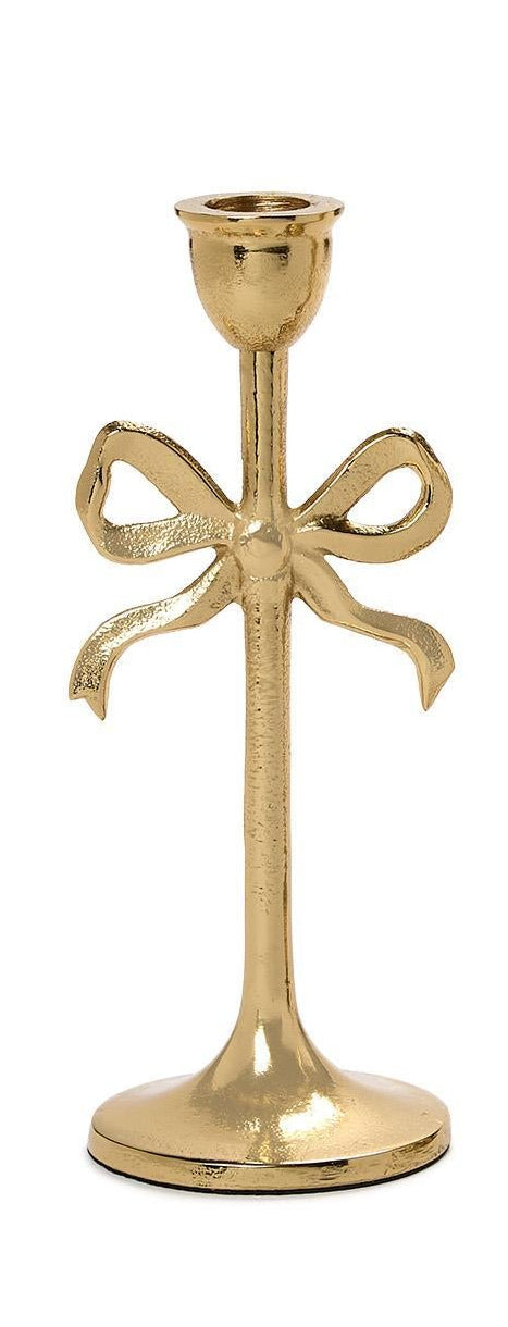 Gold candle holder with bow design on a white background