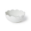White ceramic bowl with scalloped edge on a white background