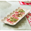 Decorative cookies on a rectangle plate with scalloped edges.