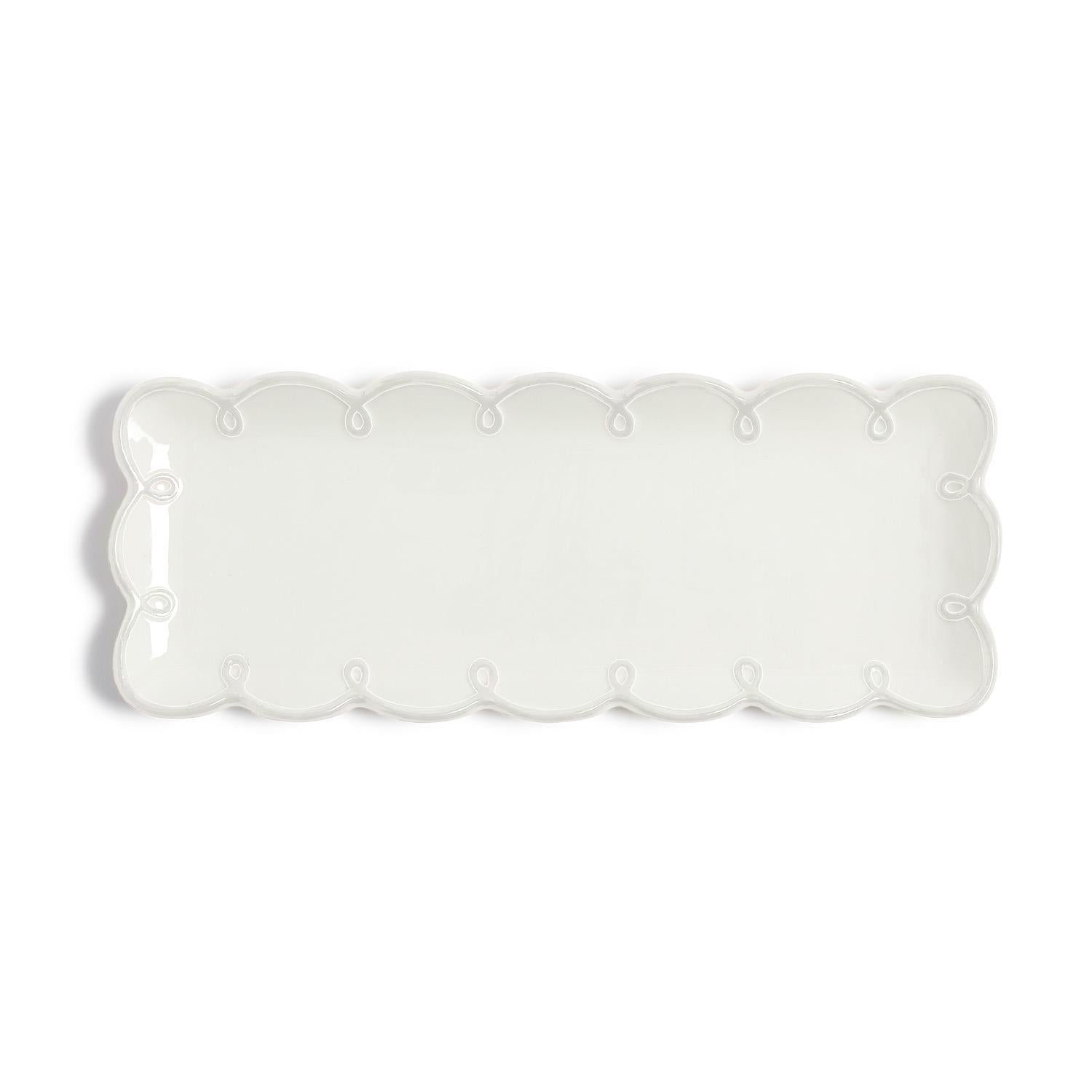 Rectangular white dolomite plate with scalloped edge on a white background