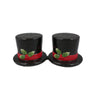 Two black top hats with red bands and green holly leaves and berries on a white background