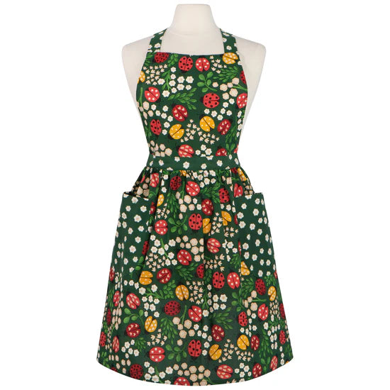 Floral apron with ladybugs on a mannequin against a white background