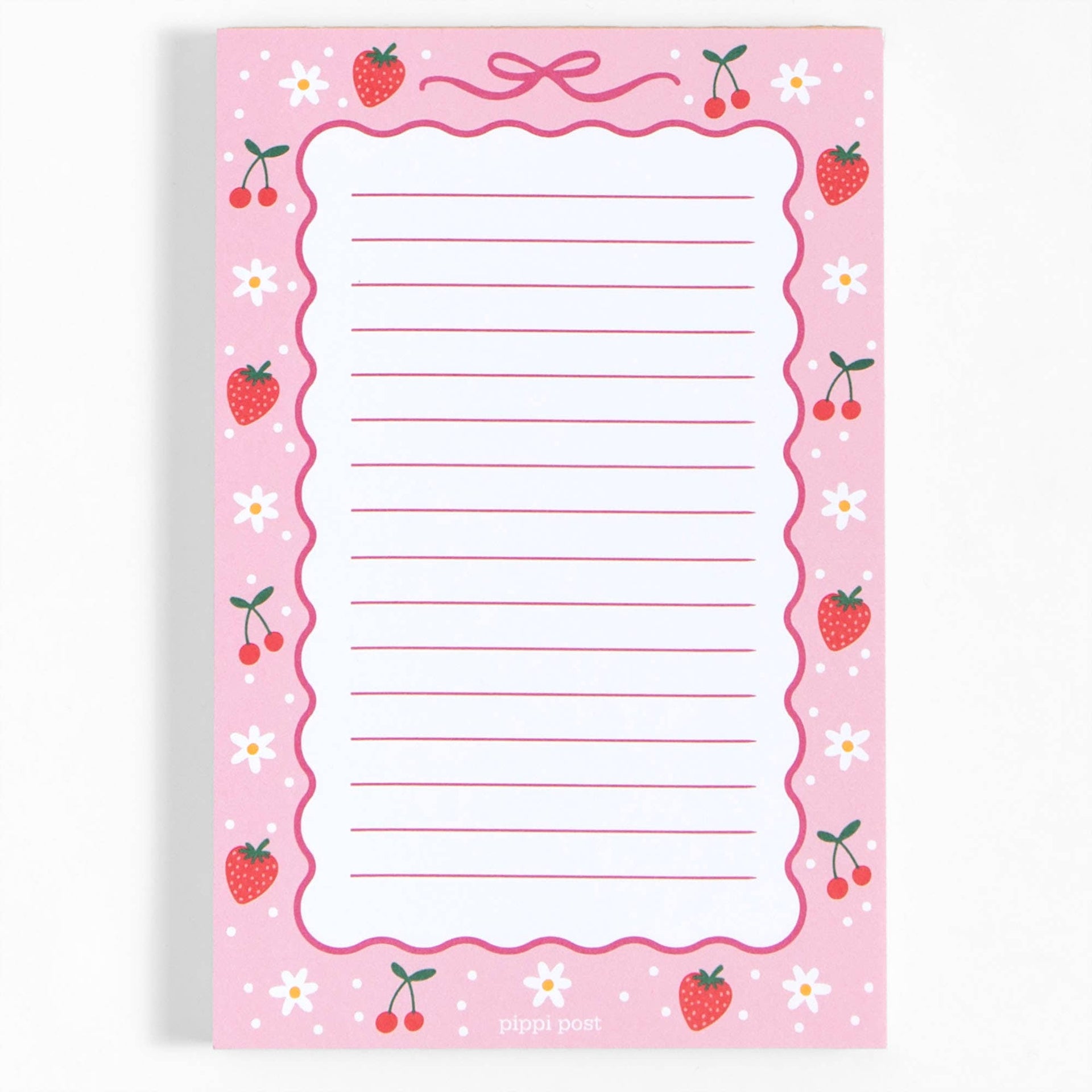 A pink lined notepad with a strawberry and cherry border design, featuring a scalloped edge and the brand name 'pippi post' at the bottom.