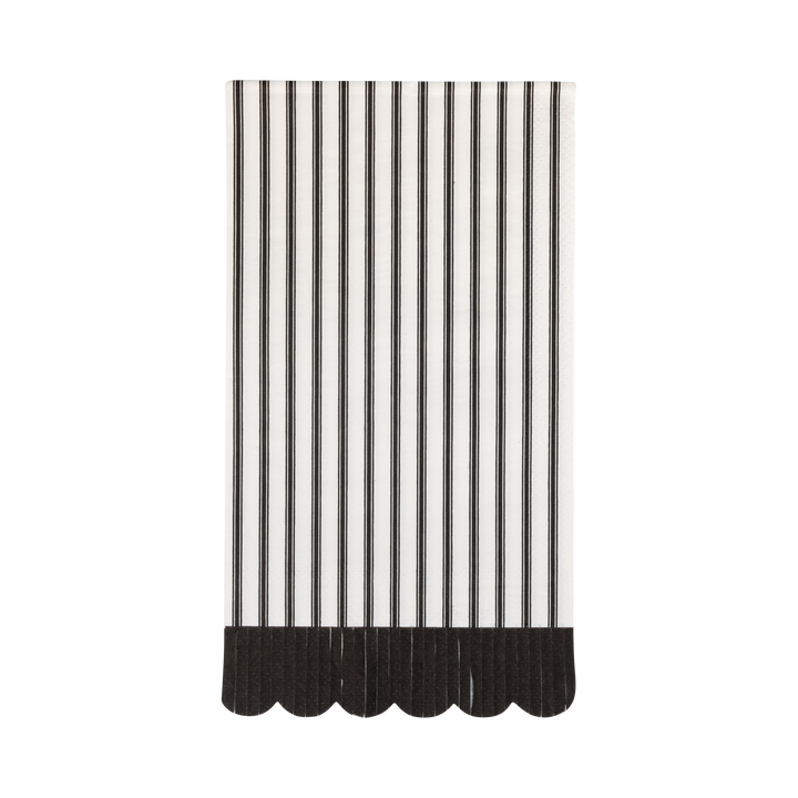Black and white striped napkin with a scalloped edge on a white background