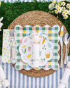 Easter-themed place setting with bunny plate, checkered plate, and striped tablecloth