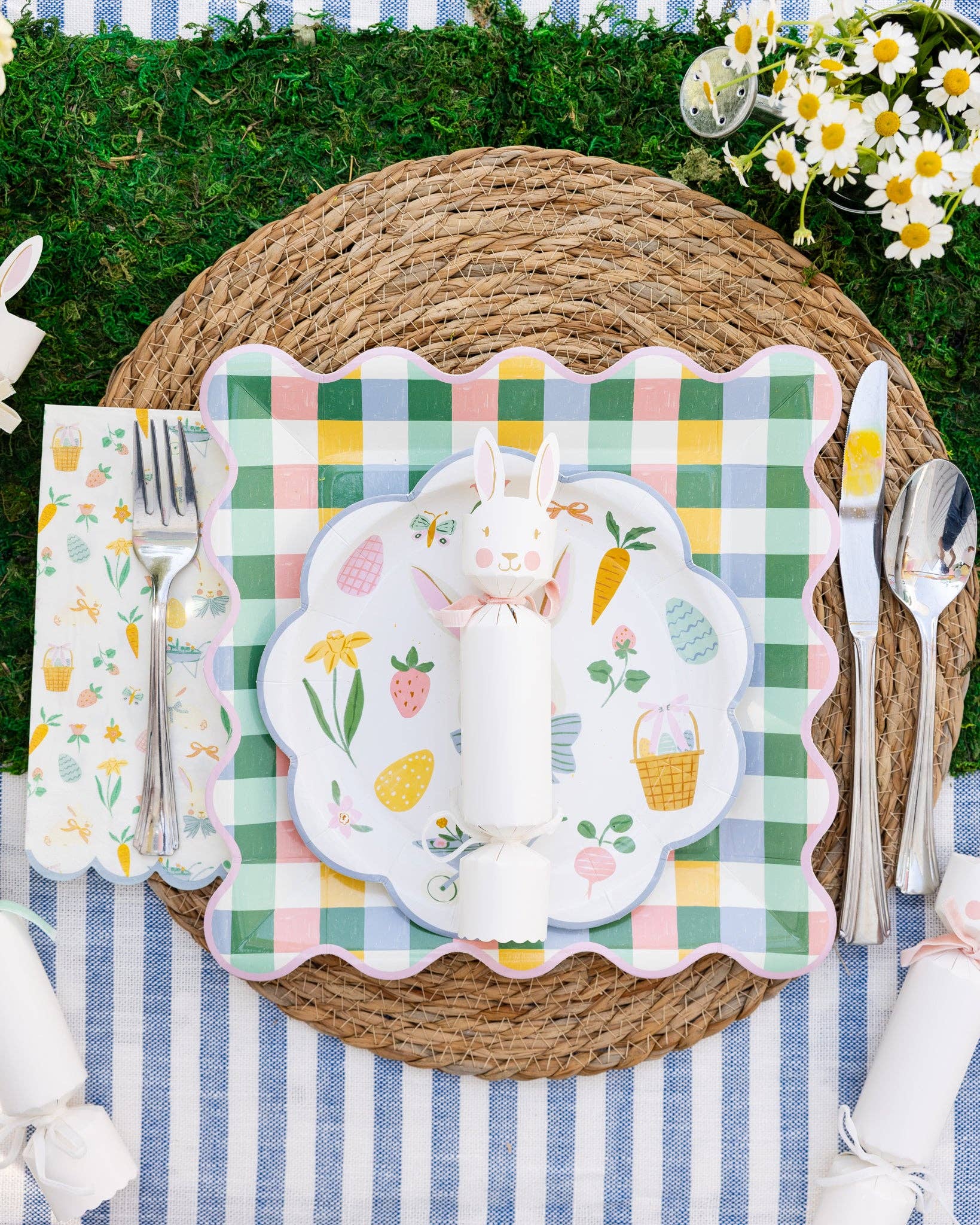Easter-themed place setting with bunny plate, checkered plate, and striped tablecloth