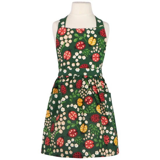 Floral apron with ladybugs on a mannequin against a white background