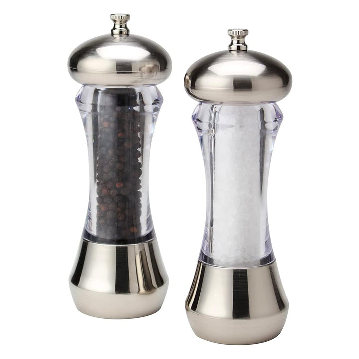 Pepper and salt mills with clear bodies and silver tops on a white background