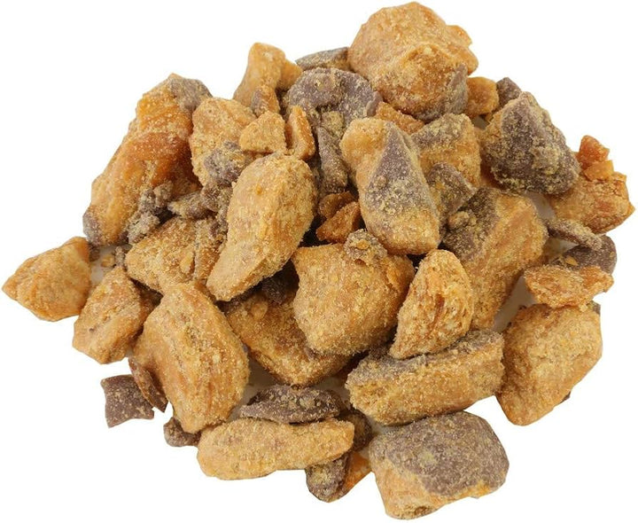 Pile of chopped Butterfinger candy bars on a white background.