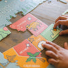 Children's puzzle with state names and symbols on a wooden table