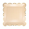 Scalloped edge plate with tan and white striped pattern and gold edging on a white background
