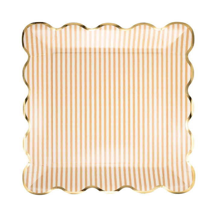 Scalloped edge plate with tan and white striped pattern and gold edging on a white background