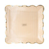 Decorative plate with gold scalloped edge and tan and white stripes on a white background