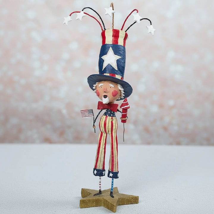 Decorative figure of a patriotic character with a top hat and American flag on a star-shaped base.