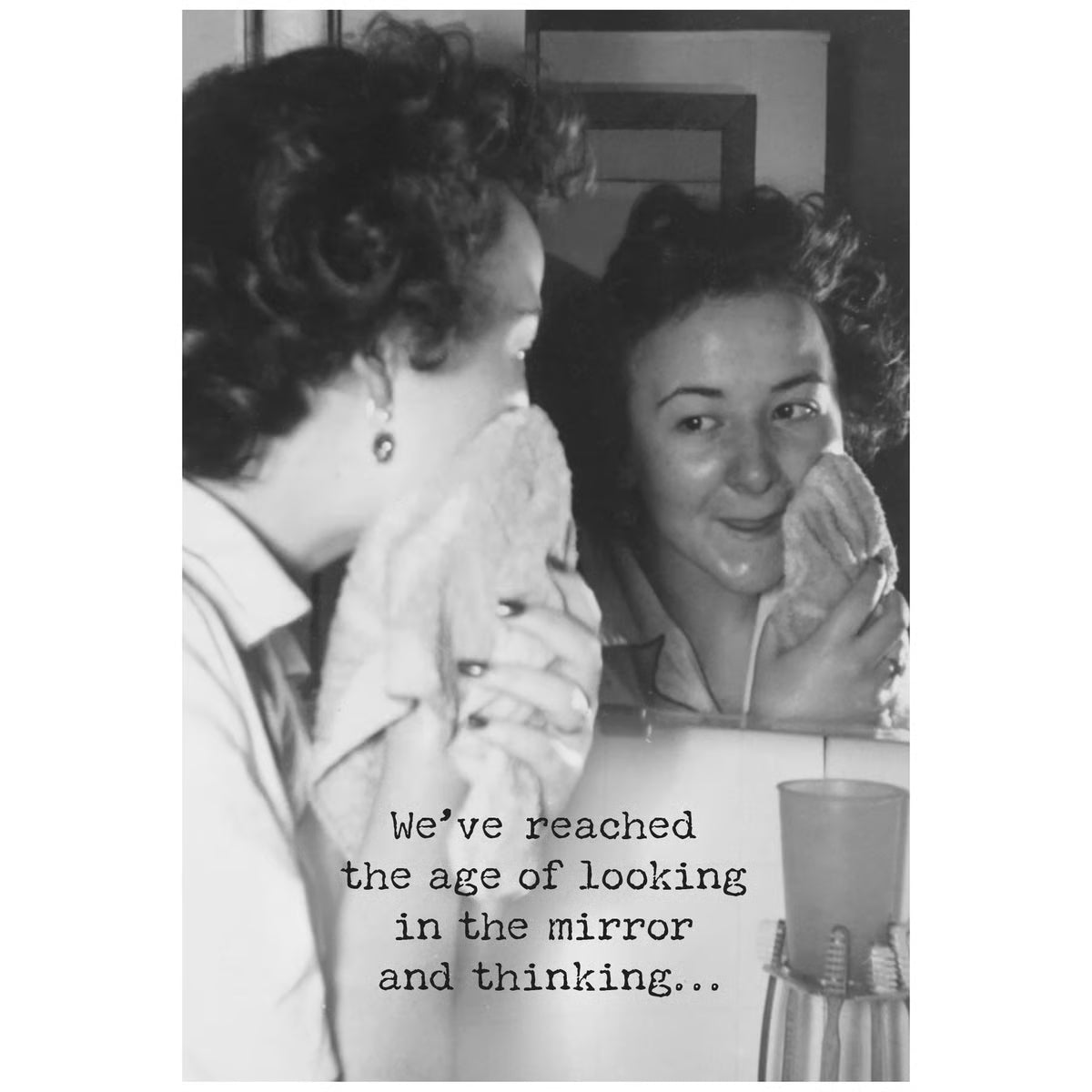 Two women looking at themselves in a mirror with a text overlay.