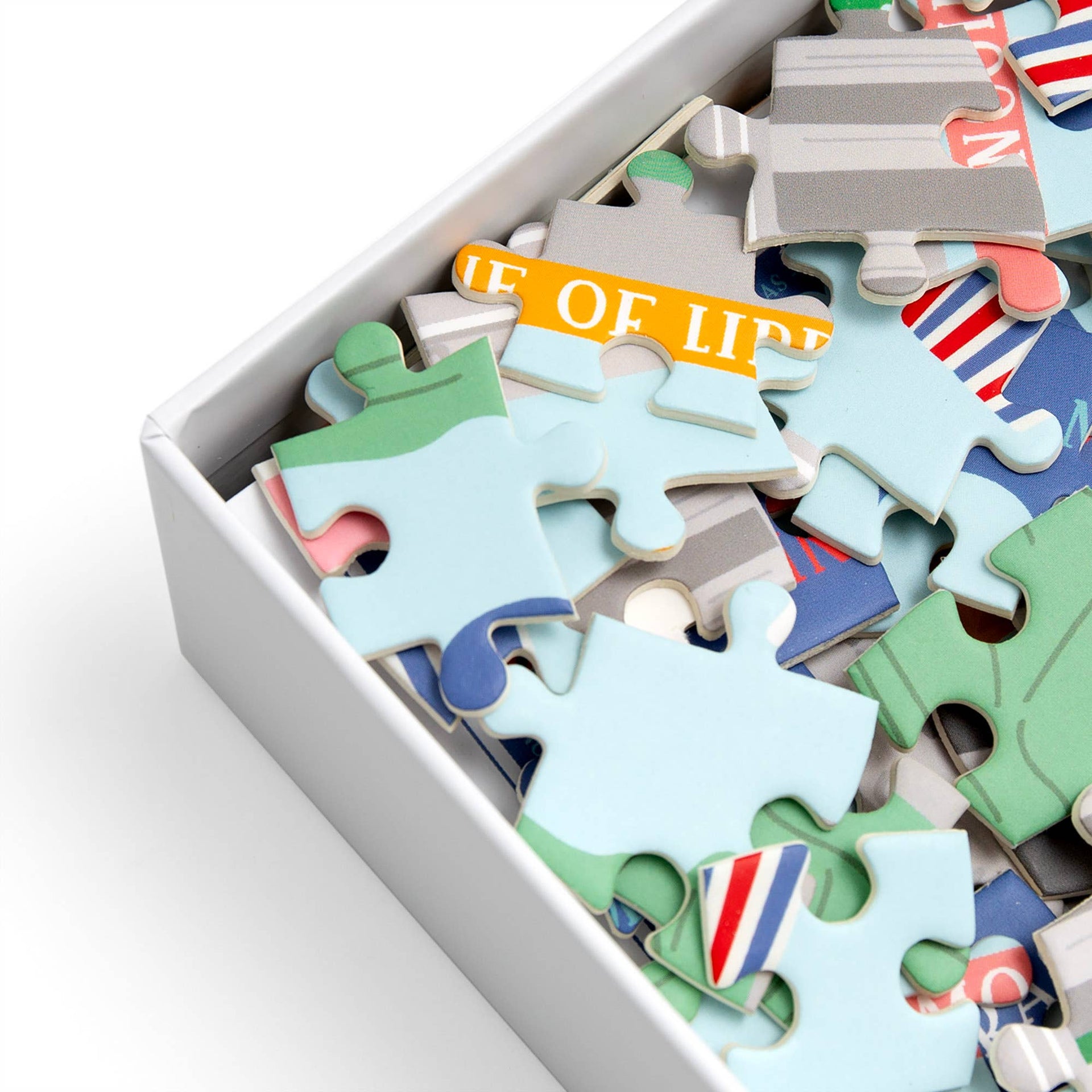 Colorful puzzle pieces in a box.