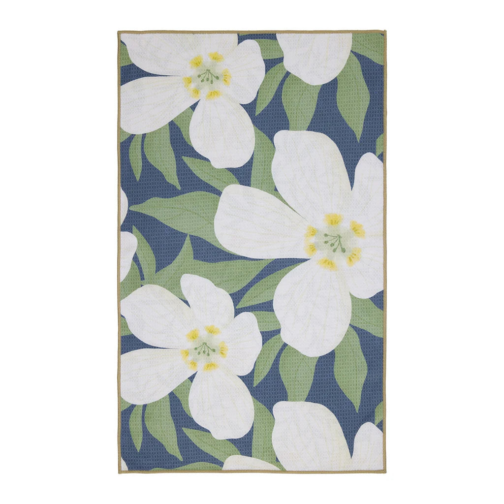 Floral patterned towel with white flowers and green leaves on a blue background
