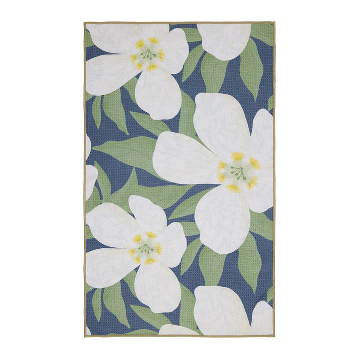 Floral patterned towel with white flowers and green leaves on a blue background