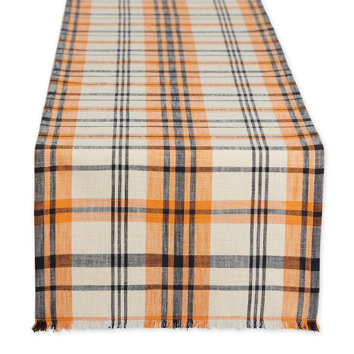 Plaid table runner with orange, black, and white pattern on a white background