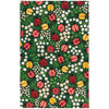 Patterned towel with ladybugs, flowers, and leaves on a green background