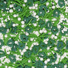 Colorful sprinkles with green tree shapes and white round sprinkles on a green background