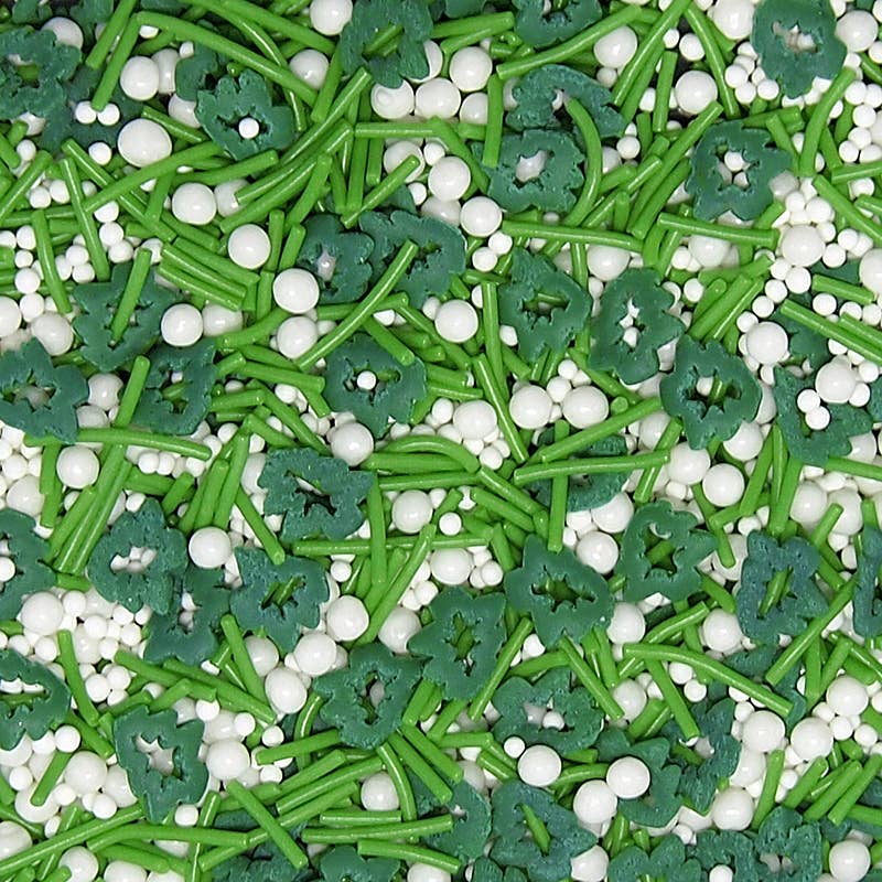 Colorful sprinkles with green tree shapes and white round sprinkles on a green background