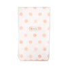 Package of napkins with pink polka dots and a brand label on a white background