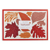 Pack of paper placemats with leaf design on a white background