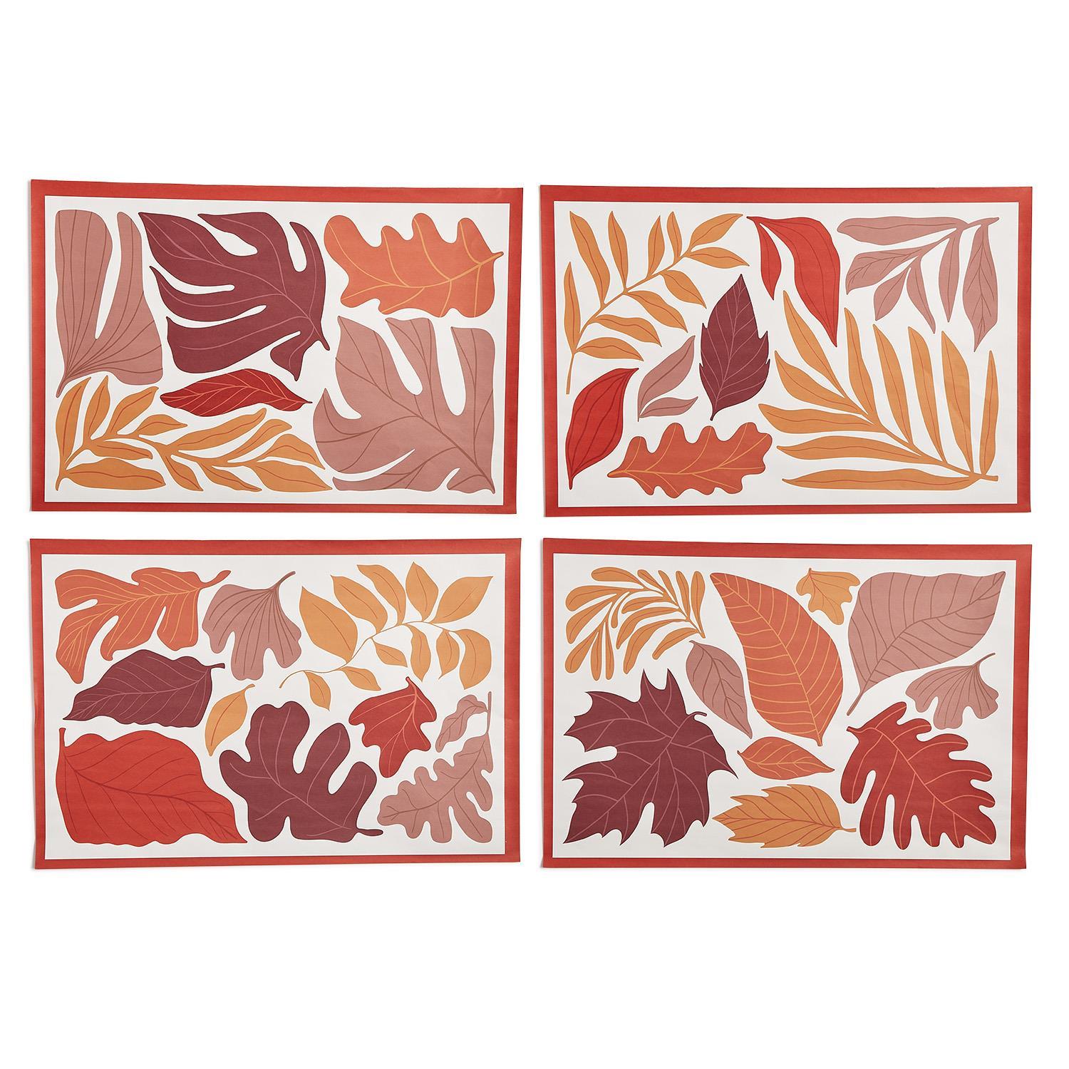Four leaf-patterned paper placemats with a red border on a white background