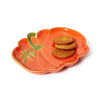 Orange pumpkin-shaped plate with cookies on a white background